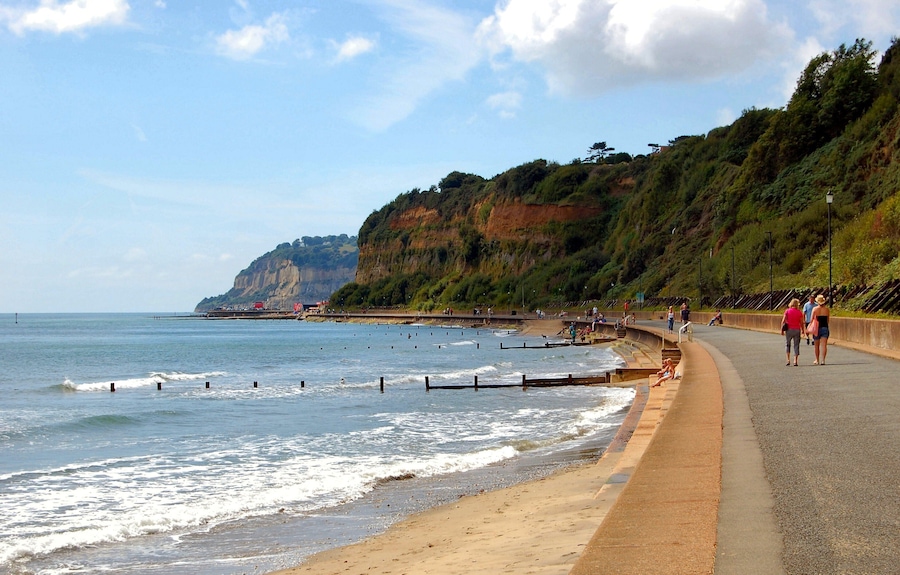 Sandown Bay is a broad bay which stretches for much of the length of the Isle of Wight's southeastern coast. It extends ten kilometres from Culver Cliff in the northeast to just south of Shanklin in the southwest. The towns of Shanklin and Sandown are located on the bay's coast. The seabed is a mixture of sand, shells and gravel. The beach is predominantly sand. The bay is best viewed from Culver Down to the north. The Isle of Wight Coastal Path follows the whole bayline either along the cliff top to the south of Sandown or the concrete seawall north of Sandown.