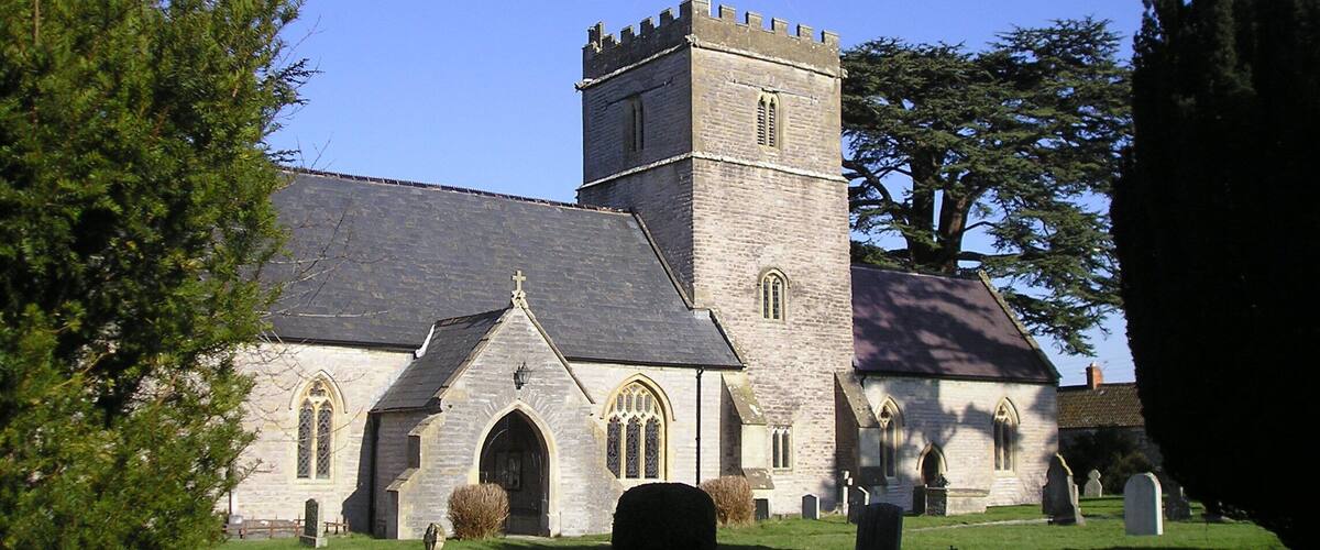 A church with a tall tower and arched windows.
