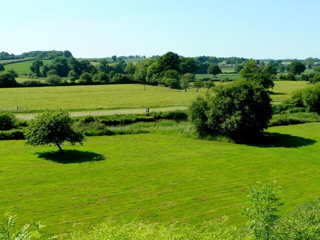 View over the Otter The two dog-walkers are over on the west side of the river, viewed from Harpford.