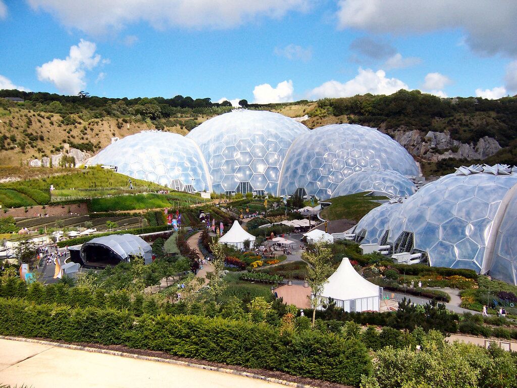 A series of large geodesic domes in a landscaped garden.
