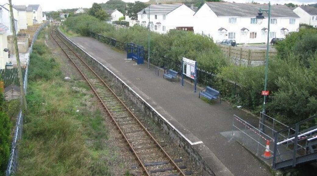 Bugle Station. This station on the Newquay branch line used to be an island platform. The second line ran in the now overgrown area between the platform and the white buildings at right. The station now only has pedestrian access, the station yard having been used for housing.