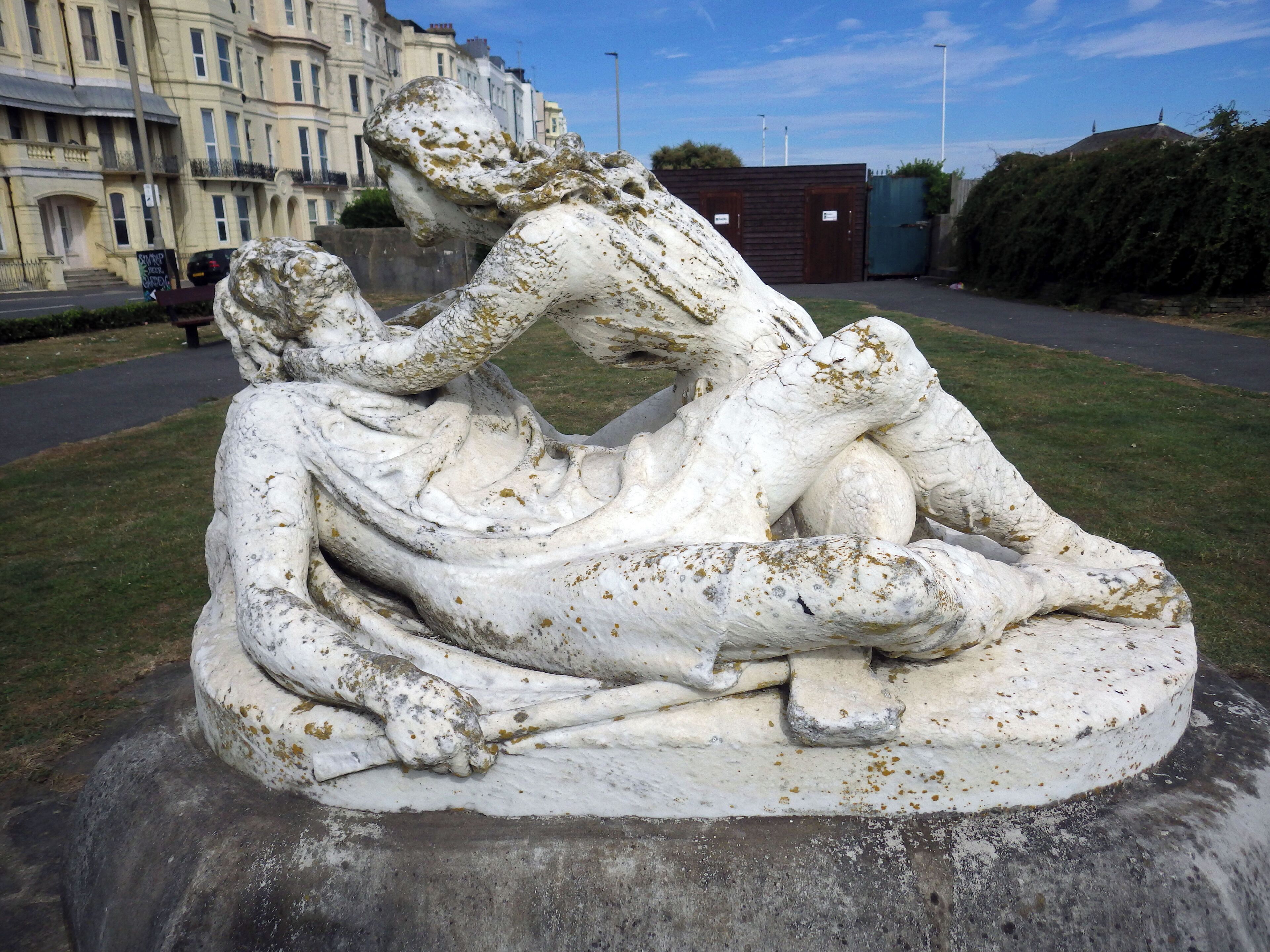Stone statue depicting King Harold II and his first wife Edith Swan-Neck (1025-1086?). Harold is depicted lying on his back dying and the figure of Edith is hunched over him, holding up his head towards her face. Artist: Charles Augustus William Wilke.