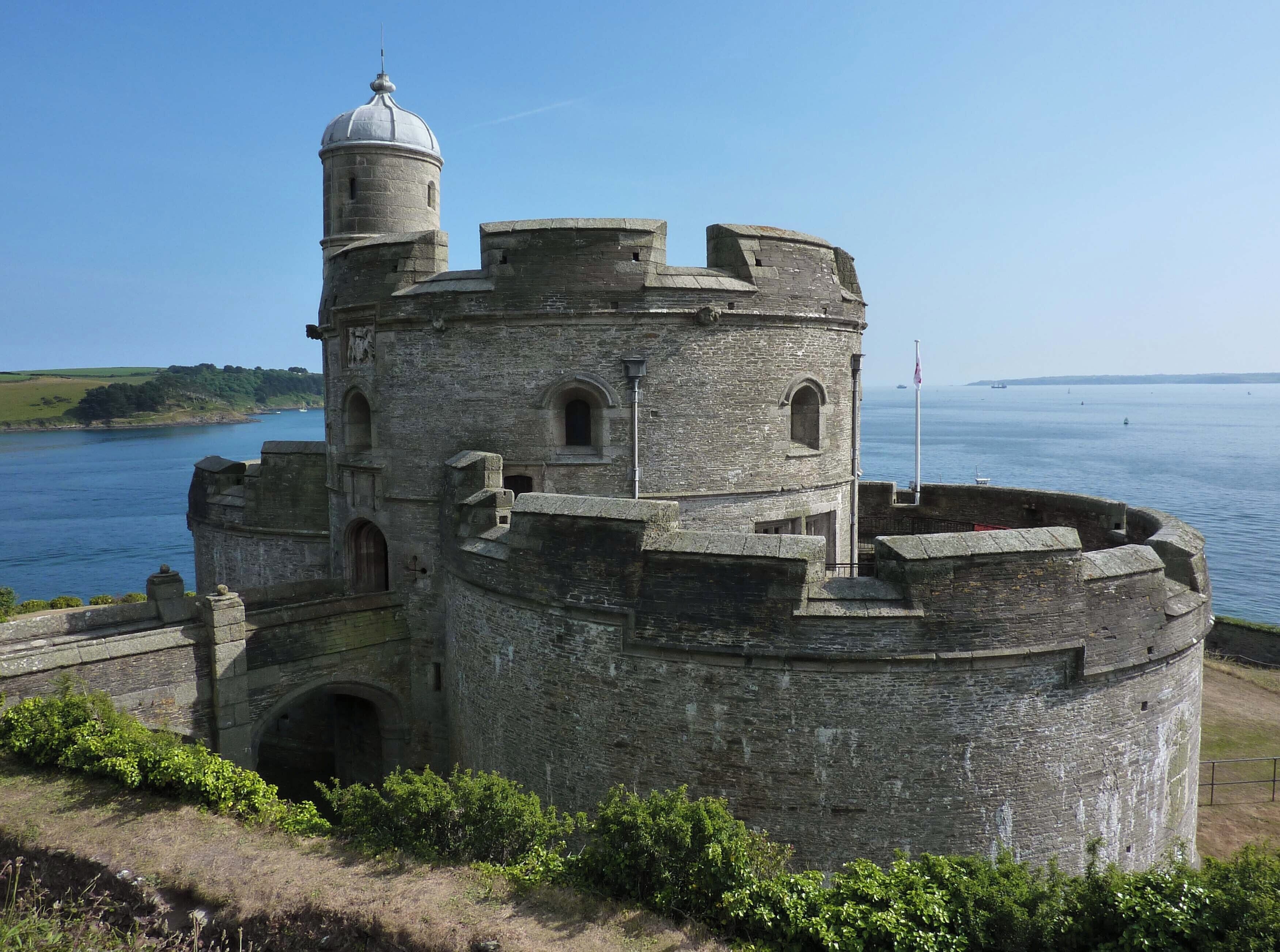 A historic stone castle by a body of water.
