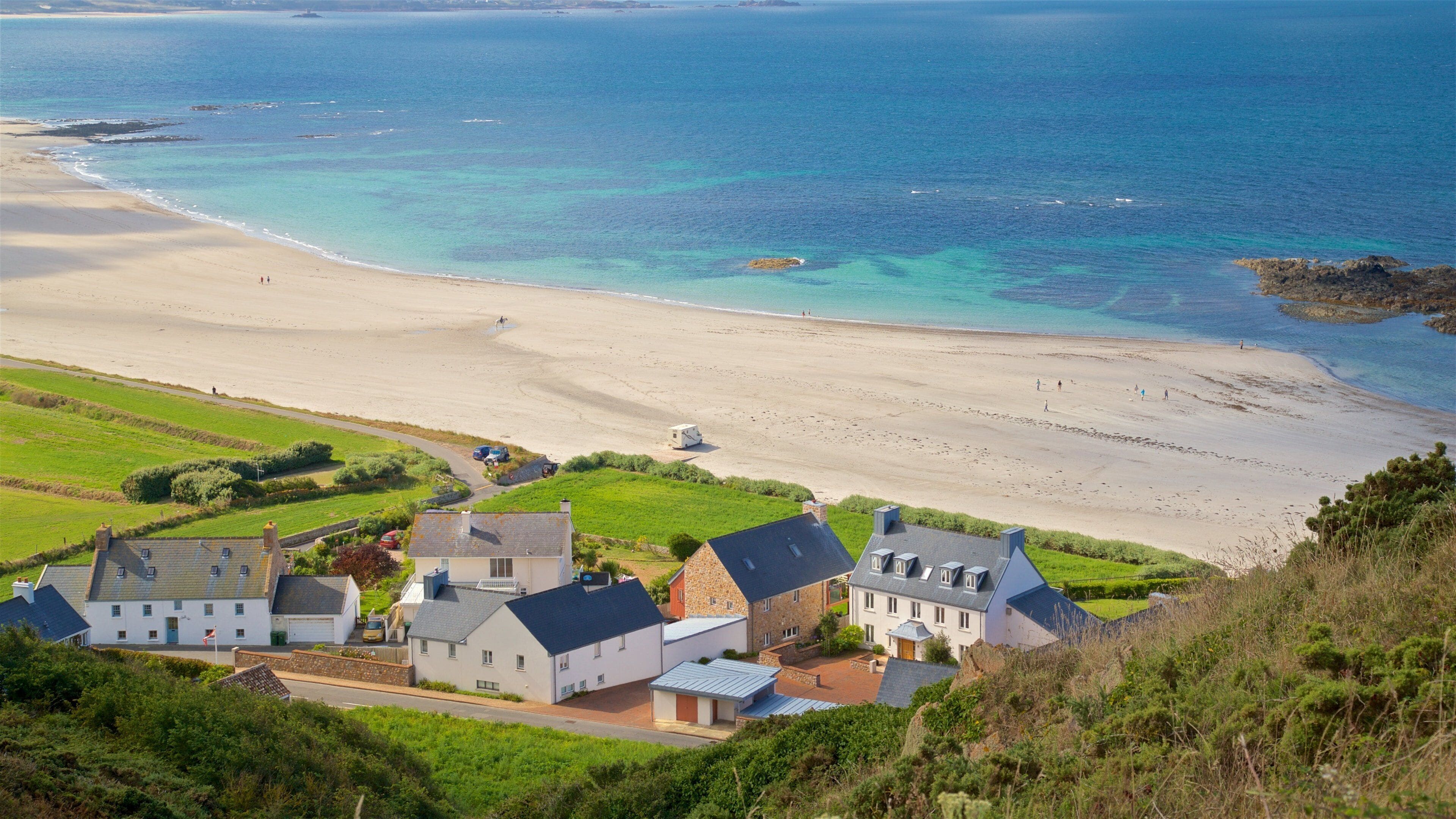 St Ouen showing a beach, a coastal town and landscape views