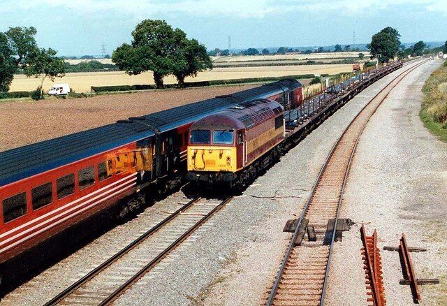 Passing Trains 56 018 heads South with a train load of steel, being passed by a Virgin HST heading for Derby.