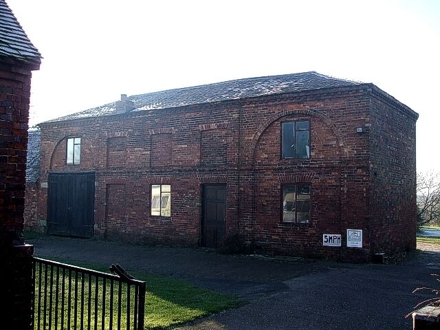 At the end of the lane, Cliff Cliff Hall Lane is a no-through-road. At the very end of the lane gates lead to this quite unusual looking building with its numerous "blind" or bricked-up windows. The sign at the bottom right says that it is a "Camping & Caravanning Club Listed Site" though looking on their website, I don't think that this is the standard way into the site.