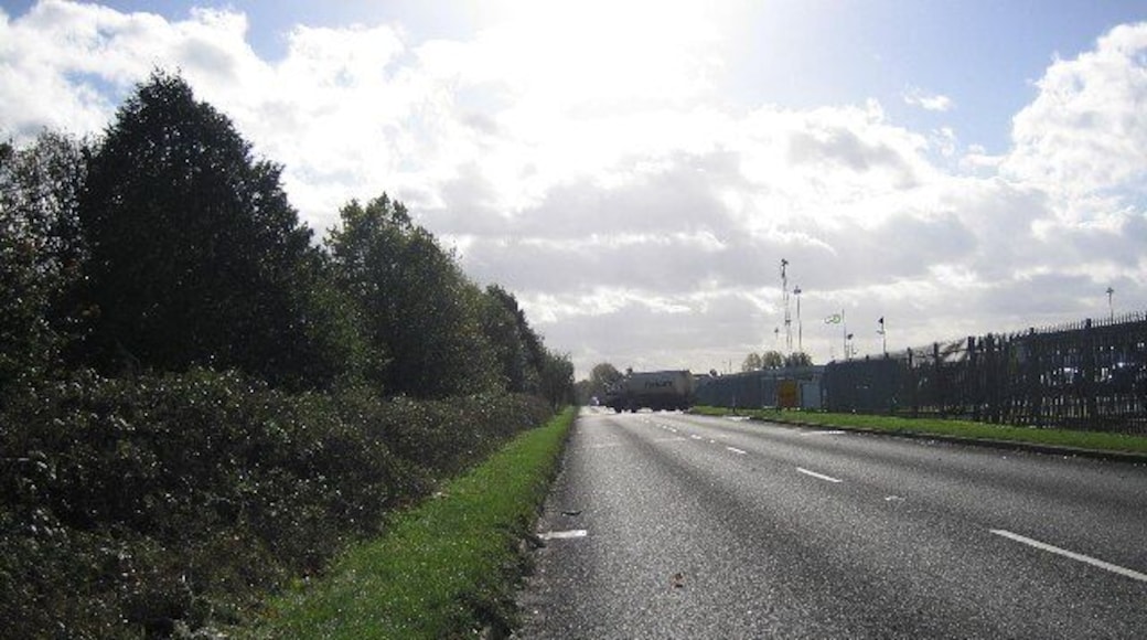 Road near Oil Depot. This long, straight stretch of road is alongside a small part of Kingsbury Oil Depot. It is fortunate that it is long and straight, so that the fully laden tankers can pull out easily. This road also acts like a mini bypass for the village of Kingsbury.
