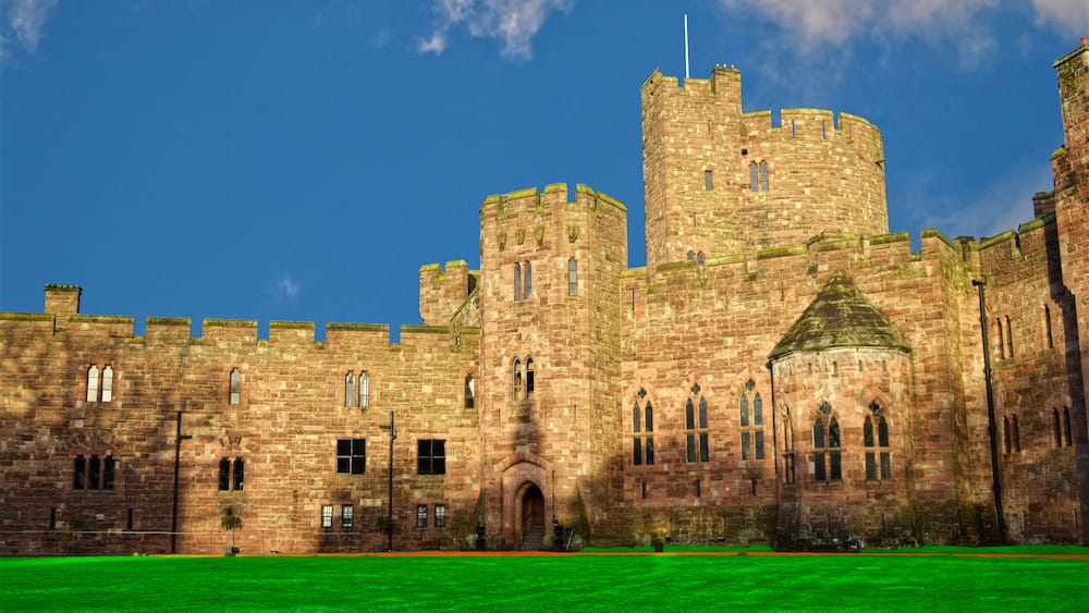 A historic stone castle with multiple towers and arched windows.