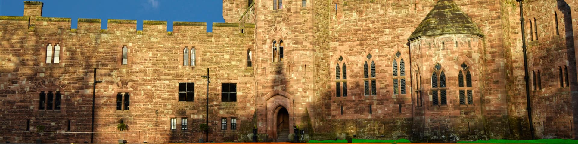 A historic stone castle with multiple towers and arched windows.