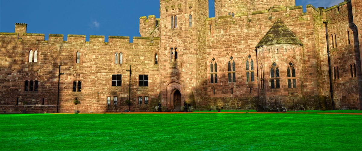 A historic stone castle with multiple towers and arched windows.
