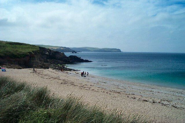 Thurlestone. South facing photo taken from Warren Bay. There's a band of divers kitting up on the beach ready to swim out and dive the popular wreck of the Louis Sheid. Over the water lies the headland of Bolt Tail.