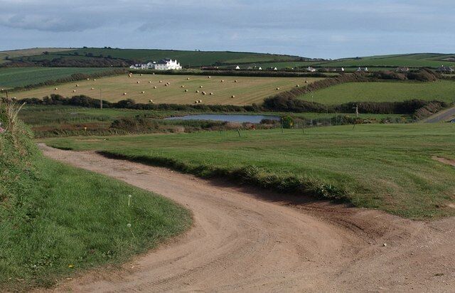 Thurlestone Marsh and Thurlestone Sands House Although the maps shows marshland and drains in the valley floor here, none of them show an actual pool. The wetland is popular with bird-spotters. A view from Thurlestone Footpath 16 at the edge of the golf course.