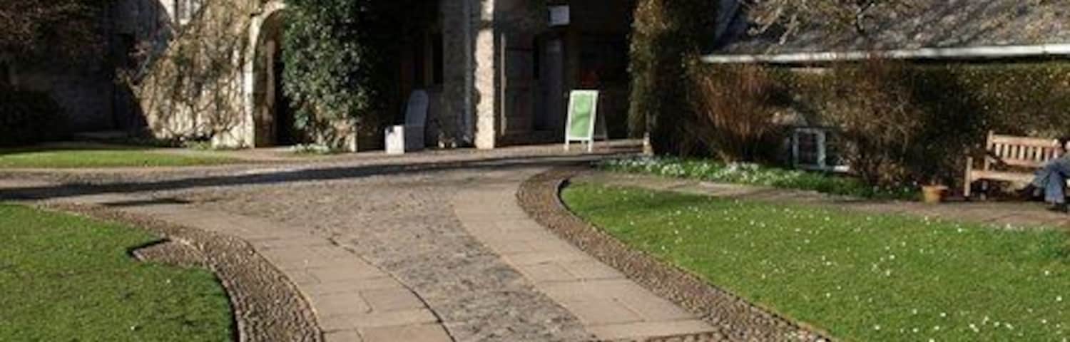 Gatehouse range, Dartington Hall "On north side of courtyard the so-called 'gate-house' range (probably workshops and dormitory)" http://www.imagesofengland.org.uk/details/default.aspx?id=101033 . As Cherry & Pevsner state: "not a proper gatehouse". But they conclude it could, like the main house, be late C14.