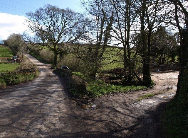 Lane to Halwell. The reverse of the view in 1242358; the lane is teetering along a northing gridline. On the right is an entrance to some farm buildings.