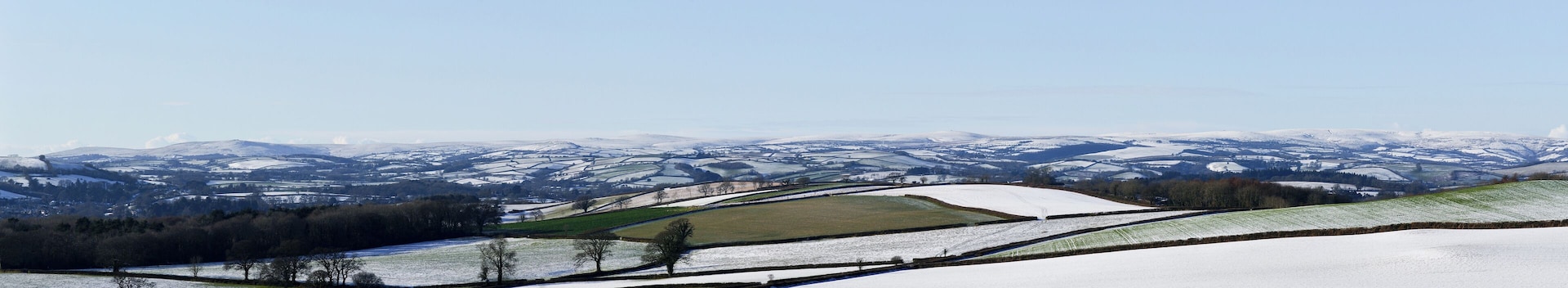 A panorama of winter in Devon, UK. The nearground shows the agricultural landscape with the southern part of Dartmoor in the distance.