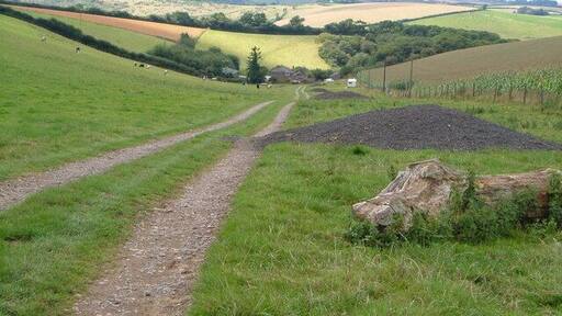 Woolcombe Farm. The only buildings in this square, taken from outside, looking down the track leading from the A381 to the farm. The valley in which the farm sits swings right beyond it past Woolcombe Wood to join the Torr Brook.