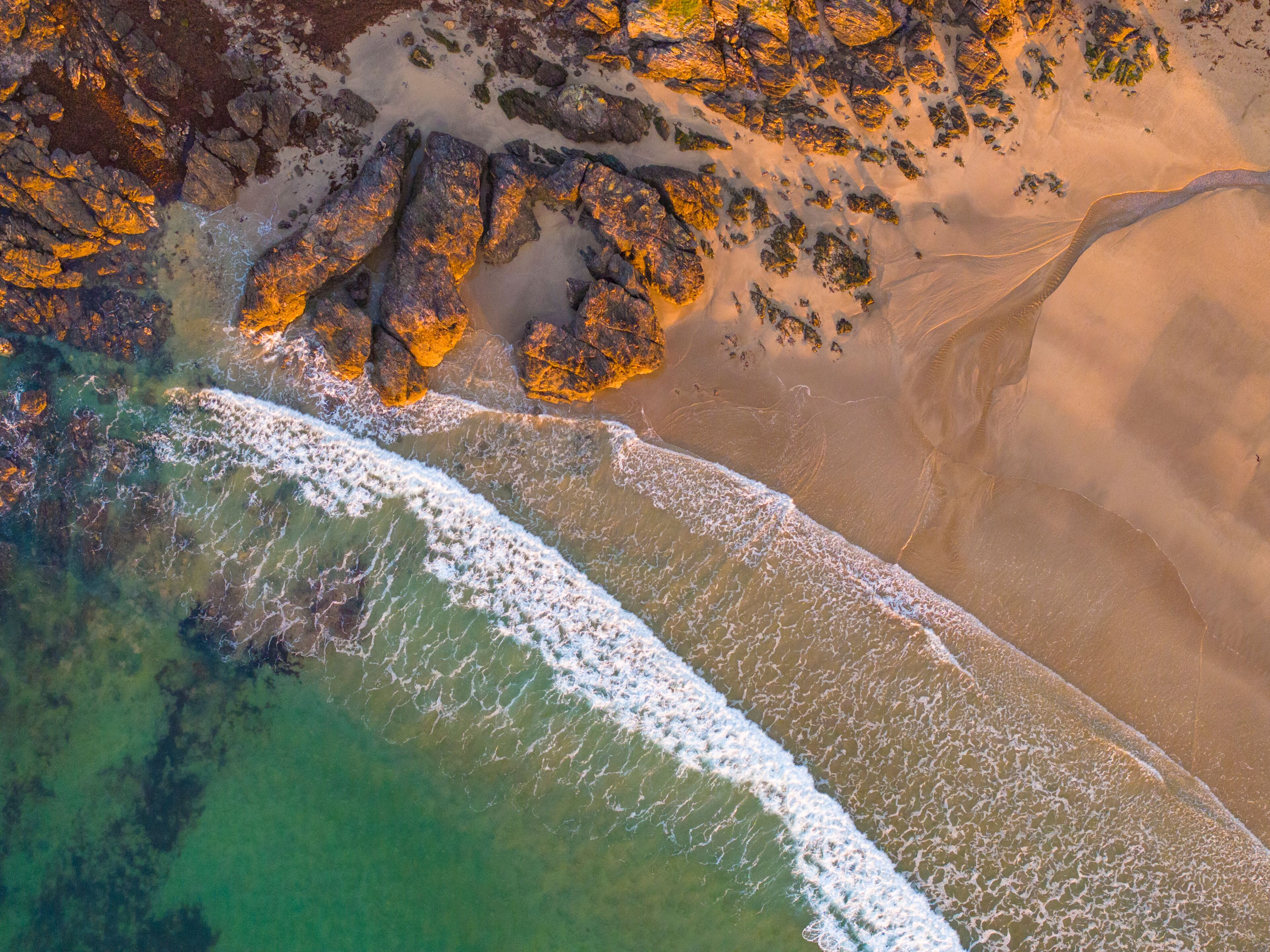 Aerial view of sandy beach with blue waves, South Devon, Lannacombe Beach, Kingsbridge, England.