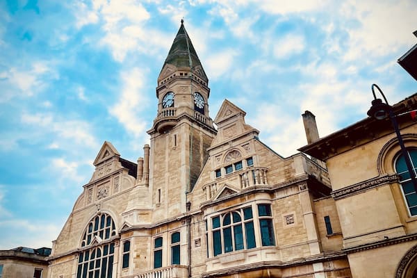 A historic building with a prominent clock tower and arched windows.
