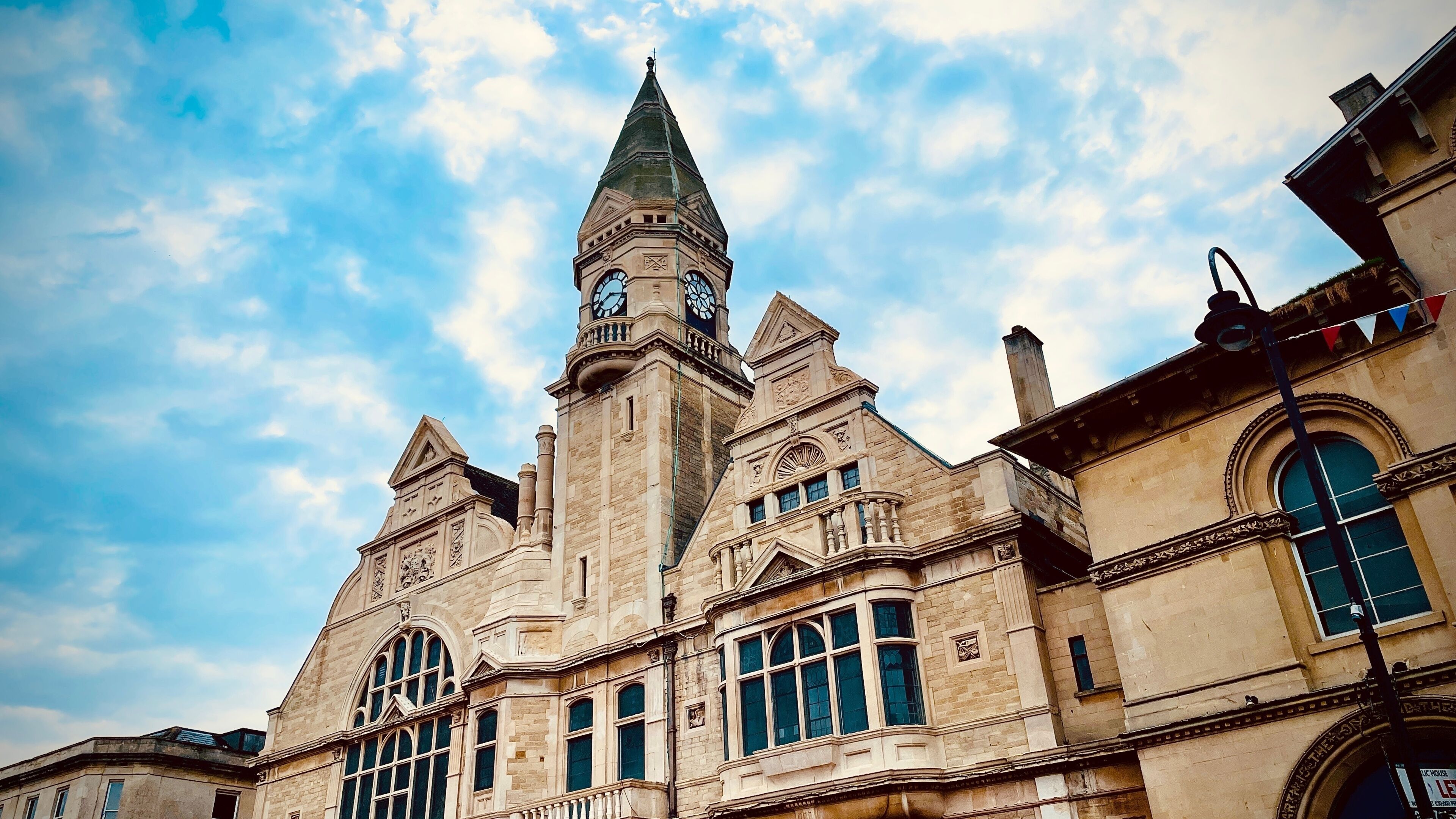 A historic building with a prominent clock tower and arched windows.