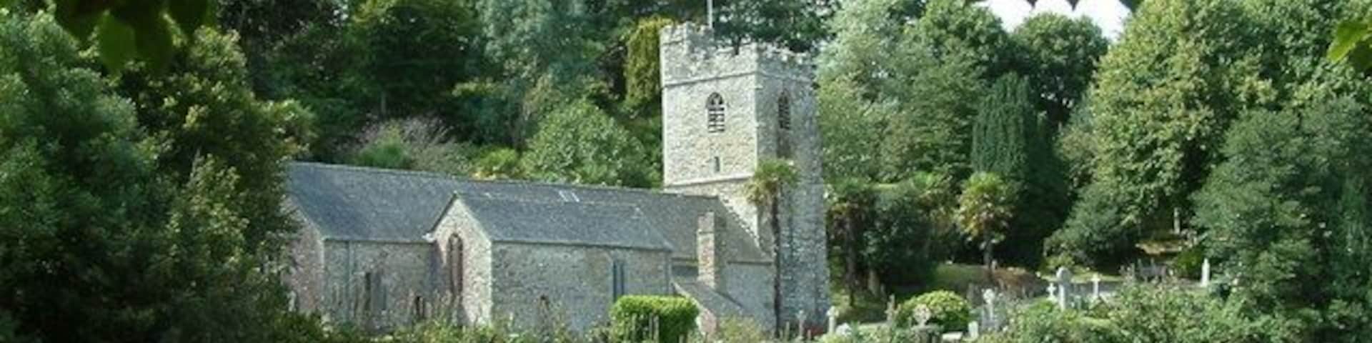 St. Just In Roseland Parish Church. When the tide is in, the water comes right up to the trees on the left and makes a much better picture than the mud than can be seen now.
