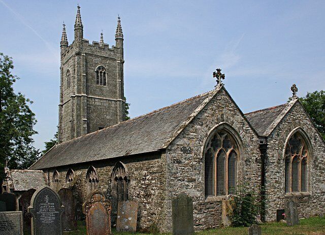 A historic stone church with a tall bell tower and arched windows.