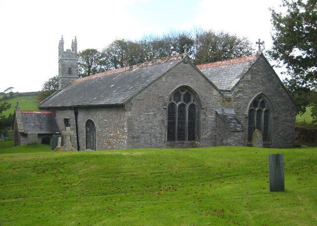A stone church with a steeple and arched windows.