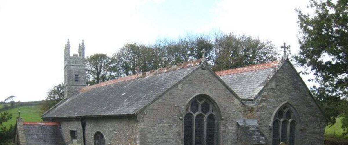 A stone church with a steeple and arched windows.