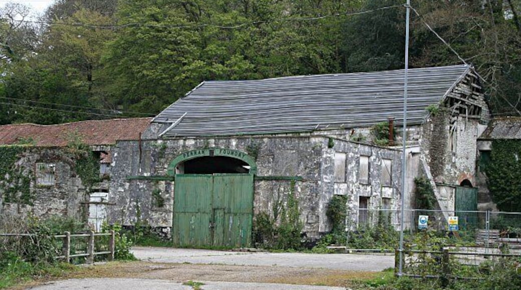 The Perran Foundry. This derelict industrial site awaiting "sympathetic redevelopment" is of international significance. Above the green door, the name plate shows the year 1791 as the date of establishment of the foundry. The foundry was most active from the 1820's to the 1860's when it made and shipped huge mine pumping engines all over the world. Engines created here were sent to mines in South Australia, Mexico and South Africa. Along with each engine, the company would normally send an engineer to assemble, install and run the engine.