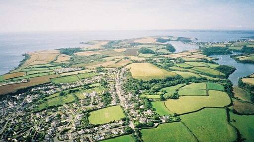 Aerial view from Paramotor of Roseland Peninsula - Portscatho in foreground, St Anthony's Head and Fal Estuary in distance