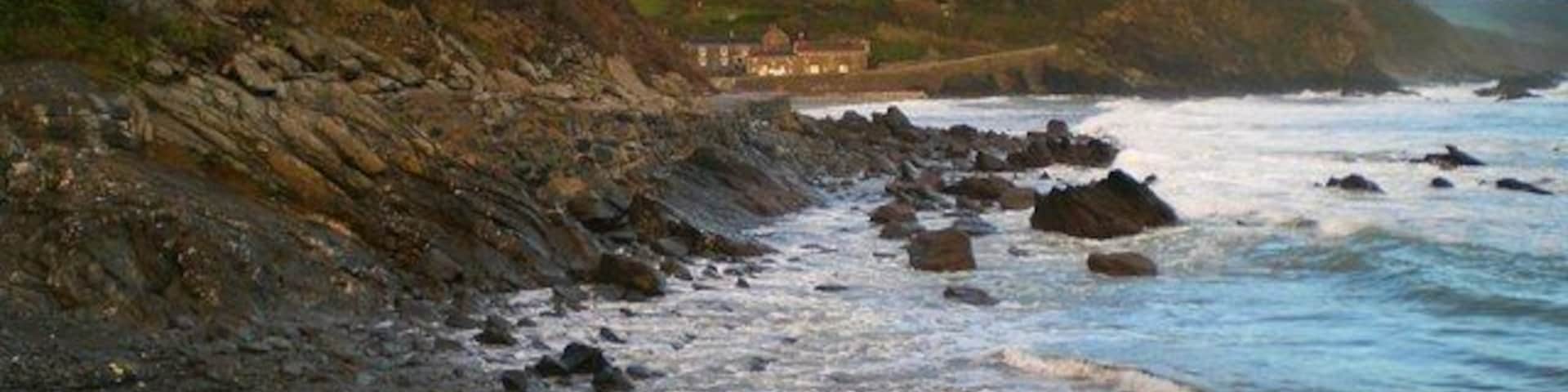 Portholland from West Portholland Portholland is a lovely secluded village by the sea. The beaches of East and West Portholland become one at low tide. The tide is in here, but going out.