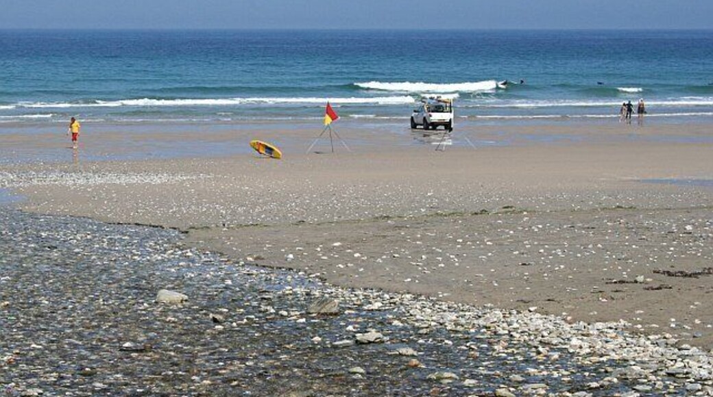 Porthtowan Beach. Not many people on the beach on this hot Summer day. It is June however. The scene here in late July or August would be much more crowded. The landrover belongs to the beach lifeguards who are keeping a close eye on the surfers at this state of the tide (half out).