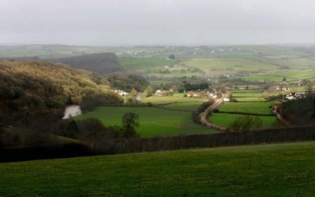 Umberleigh Village in Taw Valley Umberleigh is a scattered village but it is also a postal district serving several other villages. This shot shows the geographical location between a steep wooded escarpment and alluvial land. The Taw is in spate on the left and the Tarka Line railway runs into the station centre right. It is served by the A377 which runs from Exeter to Barnstaple which is hidden in trees West of the river.