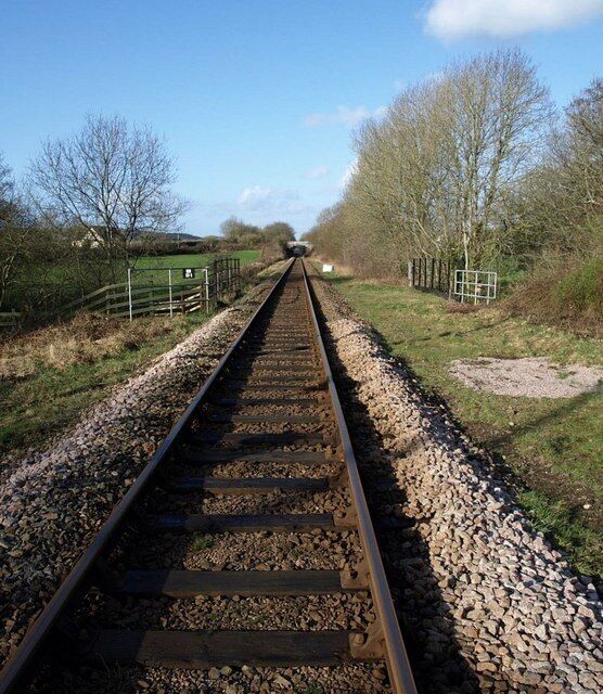 Railway line, Chapelton Looking in the direction of Barnstaple from the footpath crossing. The fence indicates the crossing of Langham Lake.