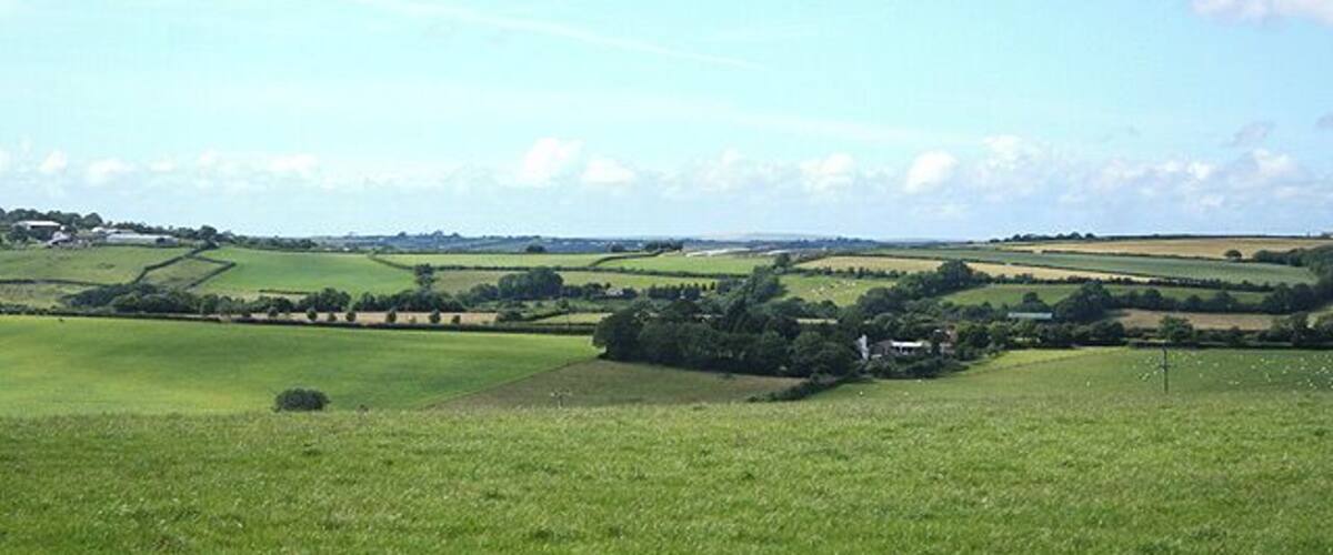 High Bickington: towards Lower Chapple Lower Chapple stands on the site of St Johns Chapel, within the square and by the Atherington Torrington road. It can be seen on the horizon on the extreme left. Looking north-north-west
