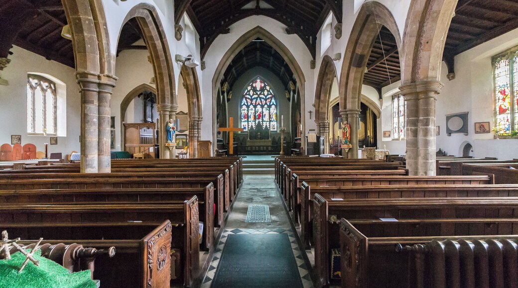 No church is mentioned in the Domesday book, although it may be identified with one of three churches attached to the Manor of Ridlington, north of Ayston. It was granted to the Abbey of Westminster in the eleventh century. The church itself dates from the fourteenth century onwards and consists of a western tower, nave with north and south aisles and clerestory, chancel and north chapel, organ chamber and vestry, and north and south porches. The tower is of three stages with angle buttresses and has a tall recessed spire with three tiers of lucarnes. There are eight bells. The nave is of four bays (lengthened by one Bay in the 1861 restoration). The north aisle is from the Decorated period, the south aisle is Perpendicular. There are remnants of wall decoration on the south arcade consisting of red flowers and tendrils. The chancel was rebuilt in 1861 when it was restored by Parsons of London incorporating black marble columns to the north chapel (Lady Chapel) and organ chamber. During the reconstruction some sculptured fragments of the twelfth century were found, two of which are now built the wall on either side of the north door. A Coffin lid of the thirteenth century was also found. There is a plain mediaeval octagonal font at the west end of the nave and a two manual organ by Harrison and Harrison. The church is surrounded on the north side by the buildings of the marketplace. Pic by Jenny.
