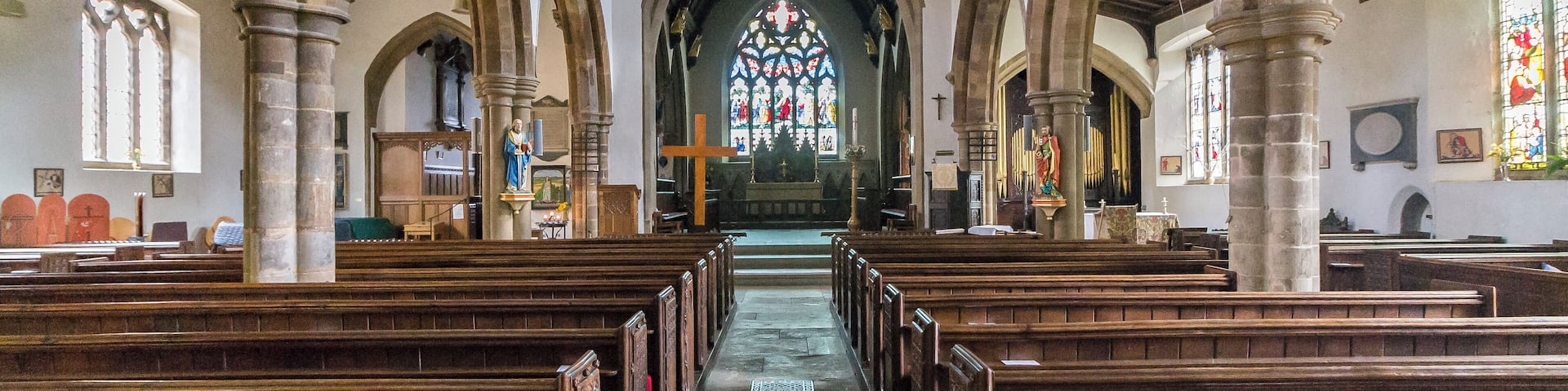 No church is mentioned in the Domesday book, although it may be identified with one of three churches attached to the Manor of Ridlington, north of Ayston. It was granted to the Abbey of Westminster in the eleventh century. The church itself dates from the fourteenth century onwards and consists of a western tower, nave with north and south aisles and clerestory, chancel and north chapel, organ chamber and vestry, and north and south porches. The tower is of three stages with angle buttresses and has a tall recessed spire with three tiers of lucarnes. There are eight bells. The nave is of four bays (lengthened by one Bay in the 1861 restoration). The north aisle is from the Decorated period, the south aisle is Perpendicular. There are remnants of wall decoration on the south arcade consisting of red flowers and tendrils. The chancel was rebuilt in 1861 when it was restored by Parsons of London incorporating black marble columns to the north chapel (Lady Chapel) and organ chamber. During the reconstruction some sculptured fragments of the twelfth century were found, two of which are now built the wall on either side of the north door. A Coffin lid of the thirteenth century was also found. There is a plain mediaeval octagonal font at the west end of the nave and a two manual organ by Harrison and Harrison. The church is surrounded on the north side by the buildings of the marketplace. Pic by Jenny.