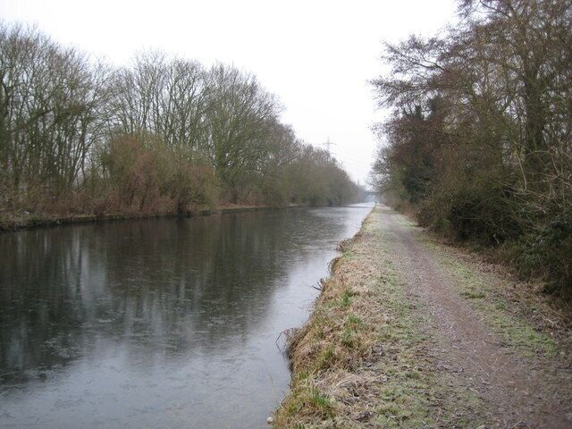 Grand Union Canal in South Harefield. The vast and deserted expanse of the Widewater reach of the Grand Union Canal, downstream of 1109992, can be seen here. Taken on the last day of 2008, the canal had a layer of ice, about 5 millimetres thick, on its surface. In the very distance is the railway viaduct seen at closer quarters in 1110066.
