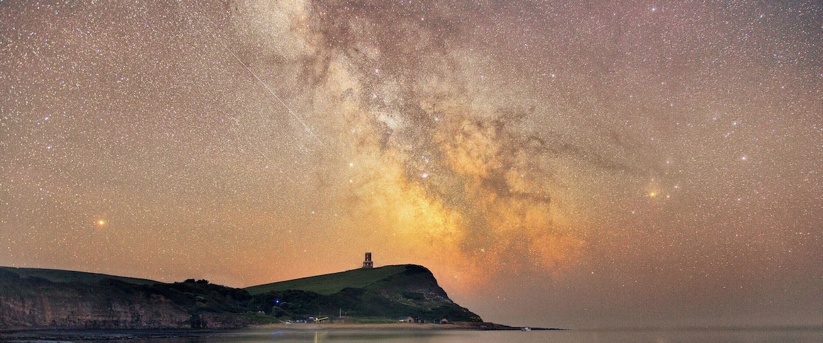 The Milky Way core rises just to the side of the Landmark Trust's Clavell Tower overlooking Kimmeridge Bay.
Two blended exposures; one 7 minutes long for the sky using a SkyWatcher Star Adventurer tracking mount, and a second 11 minute exposure for the foreground.
