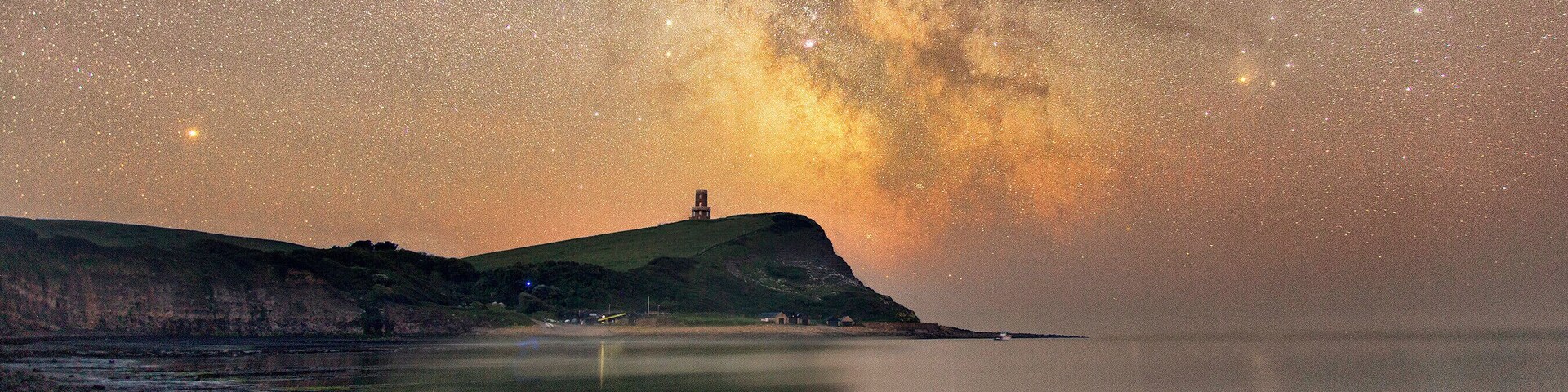 The Milky Way core rises just to the side of the Landmark Trust's Clavell Tower overlooking Kimmeridge Bay.
Two blended exposures; one 7 minutes long for the sky using a SkyWatcher Star Adventurer tracking mount, and a second 11 minute exposure for the foreground.