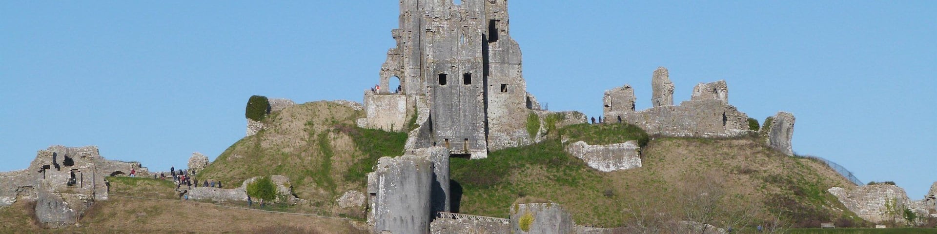 Corfe Castle is a fortification standing above the village of the same name in the English county of Dorset. Built by William the Conqueror, the castle dates back to the 11th century and commands a gap in the Purbeck Hills on the route between Wareham and Swanage.
