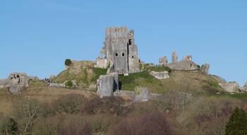 Corfe Castle is a fortification standing above the village of the same name in the English county of Dorset. Built by William the Conqueror, the castle dates back to the 11th century and commands a gap in the Purbeck Hills on the route between Wareham and Swanage.