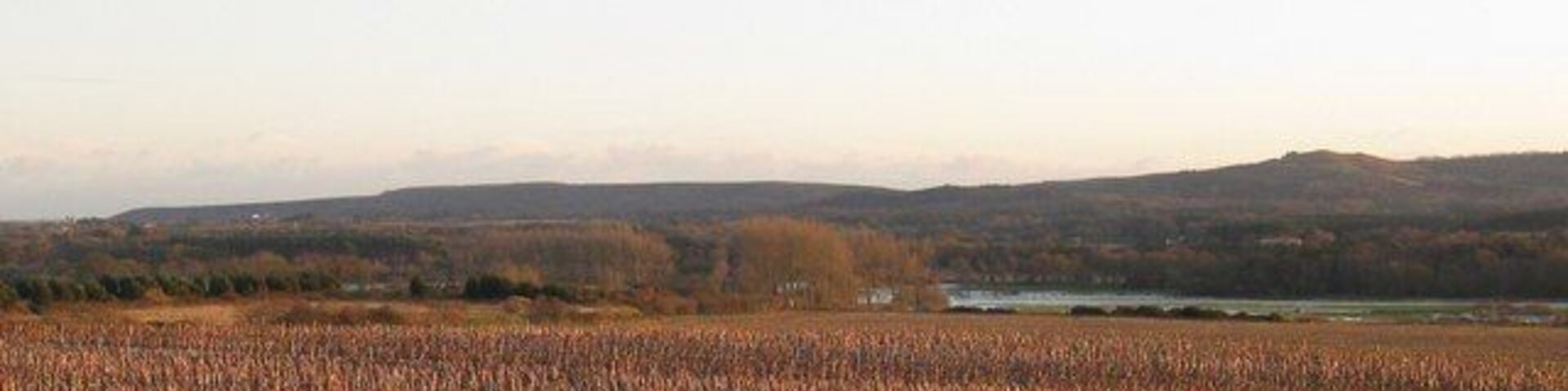 Worgret Hill - Wareham View from the west side of Worgret Hill towards the Purbeck Hills,across the stubble field to the river Frome in flood. The hill to the right is Creech Barrow SY9282. Corfe Castle is just visible to the left end of the hills.