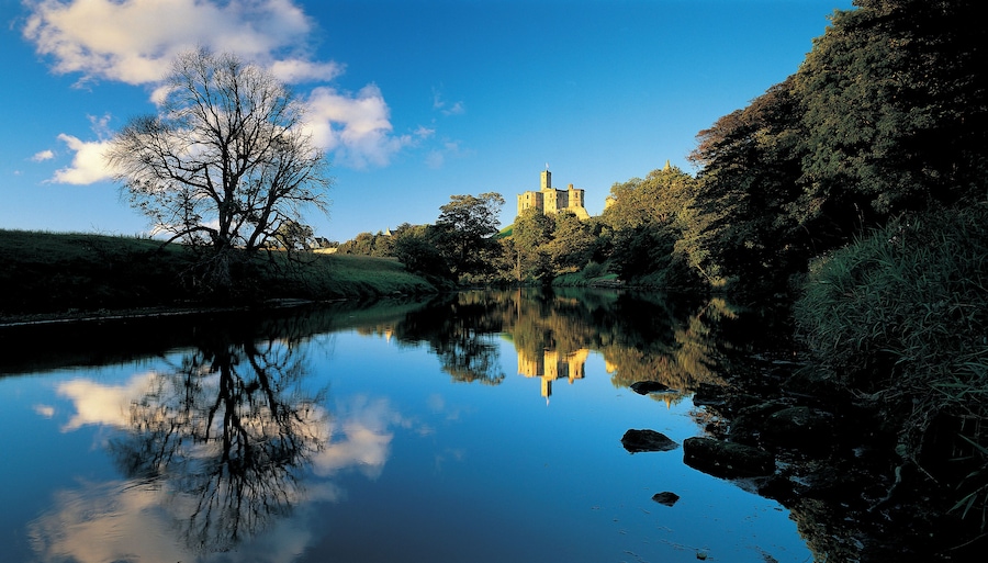 Castle overlooking reflective lake
