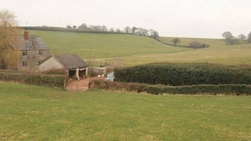 Peacehay Cottages. From footpath WG 10/9, a difficult path arriving from Devon. Peacehay Cottages are on the lane shown in 1778426, about 140 metres south of the farm across the valley that can be seen in the background.