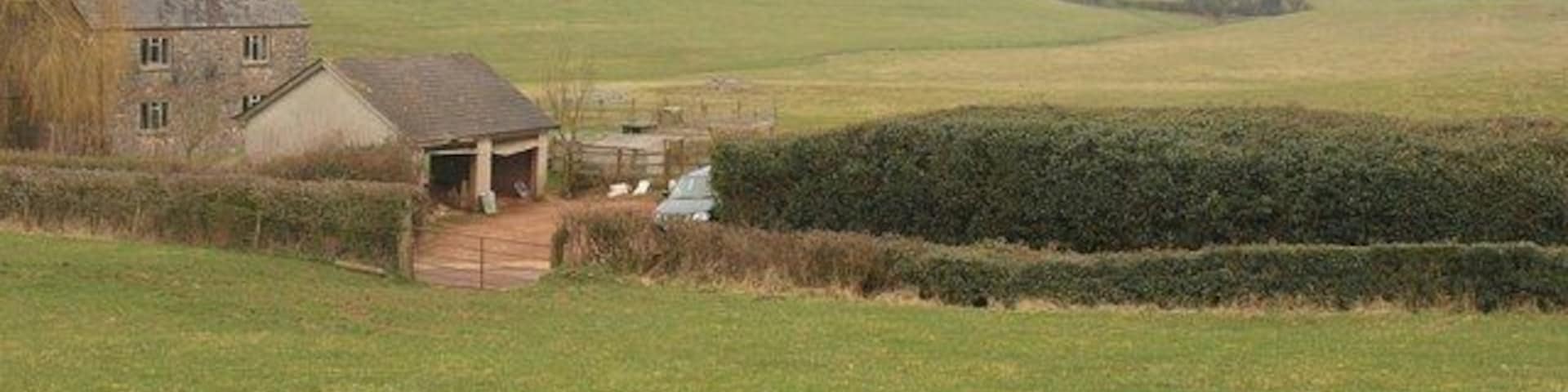 Peacehay Cottages. From footpath WG 10/9, a difficult path arriving from Devon. Peacehay Cottages are on the lane shown in 1778426, about 140 metres south of the farm across the valley that can be seen in the background.