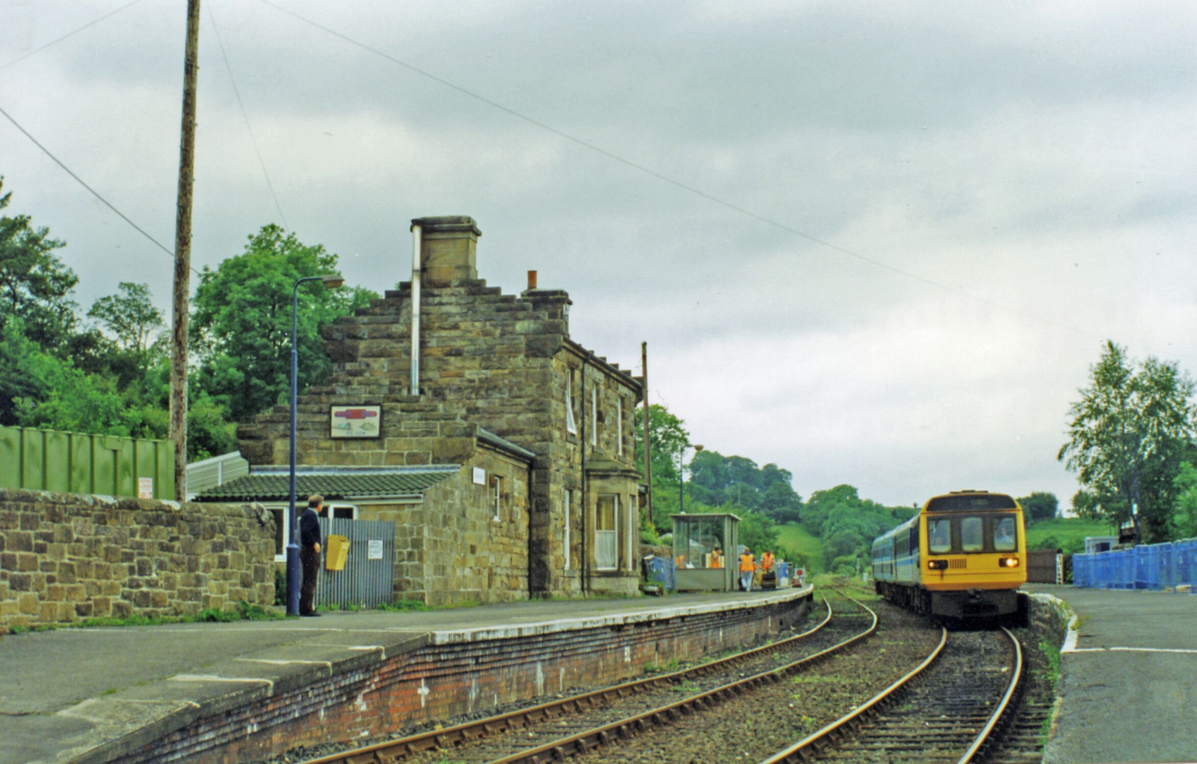 Glaisdale station, with train 1997. View SE, towards Whitby: ex-NER Scarborough - Whitby - Middlesbrough line, closed Scarborough - Whitby 8/3/65. The train arriving is a Class 142 'Pacer' DMU
