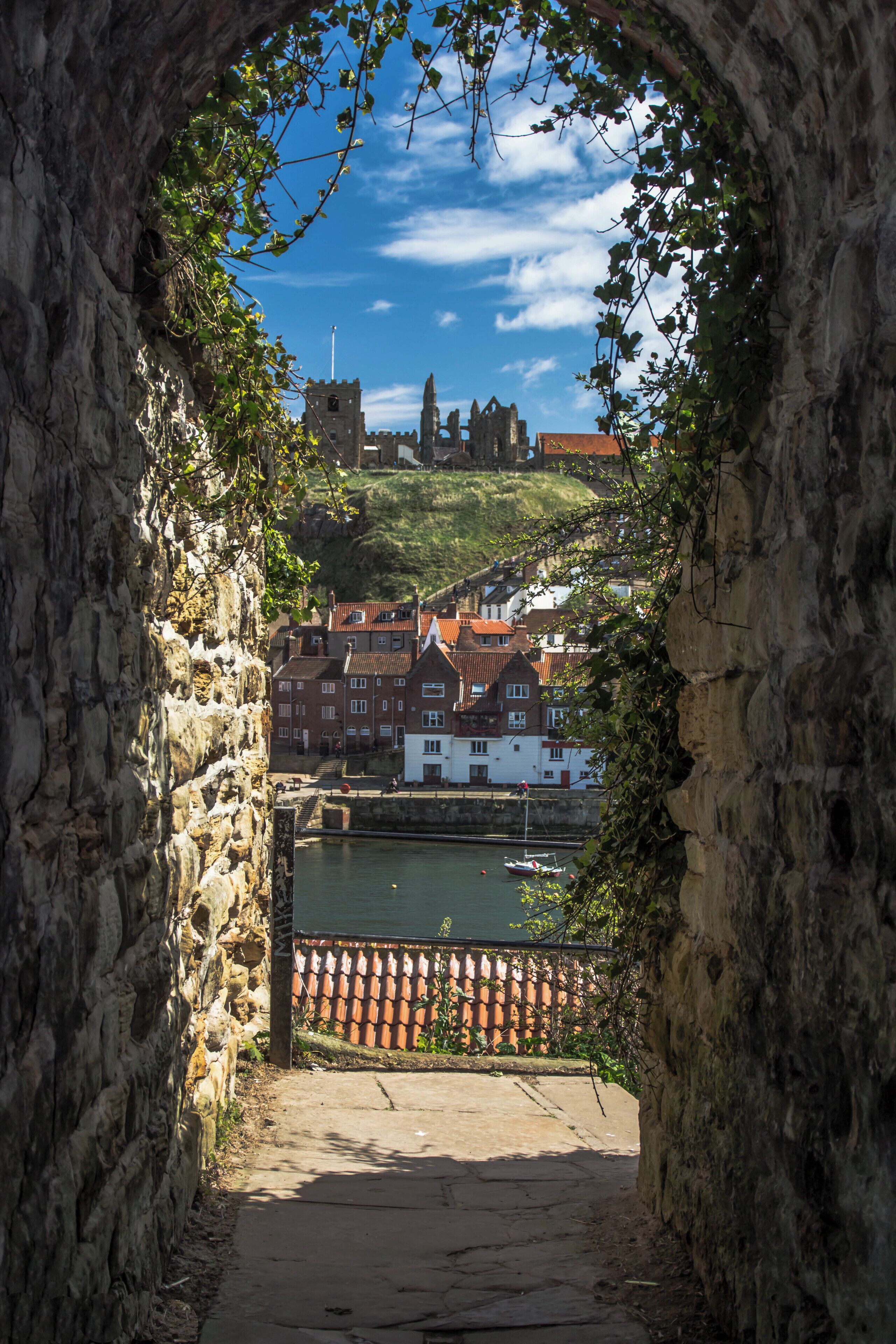 Looking through the archway towards St. Mary's Church along with Whitby Abbey, leading upto them you can also see the 199 steps which take you to the top.