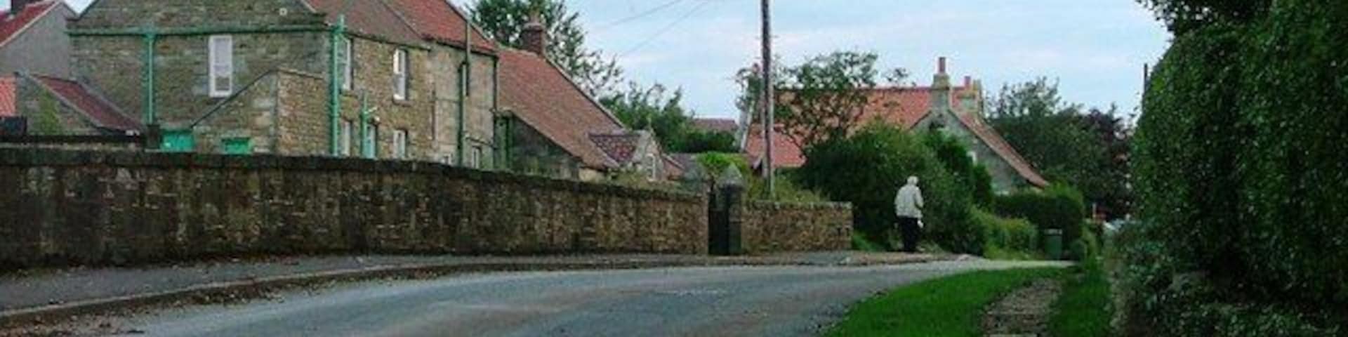 Ugthorpe. A late evening view looking west along the road towards the centre of the village taken from near Christ Church.