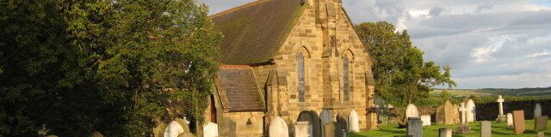 Gravestones in Ugthorpe church This photograph of Christ Church (Ugthorpe) was taken from the minor road that runs pass it - looking in the direction of Lawns Farm. The picture was taken quite late in the day - as can be seen by the direction of the shadows of the gravestones.