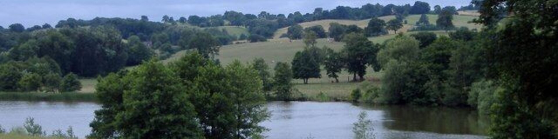 Big Mere, Marbury. Marbury. Big Mere from footpath NW of church. Most images of this mere are taken from the South Cheshire Way, which forms a popular route on the other side of the mere. This gives a different perspective, from the north side looking towards Butermilk Bank.